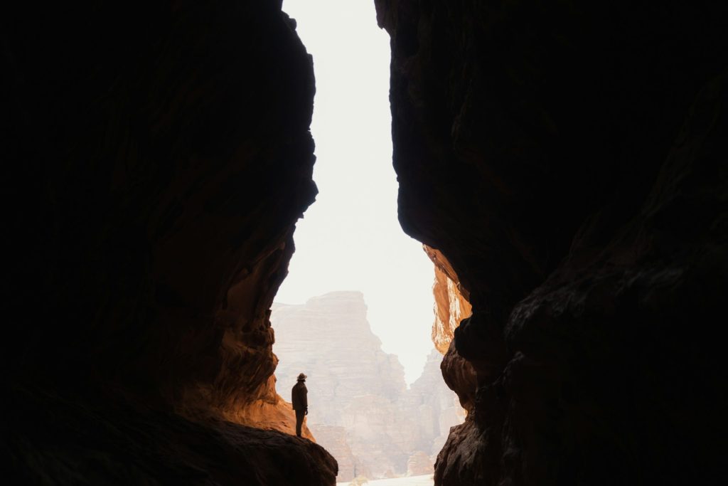 a person standing in the middle of a cave