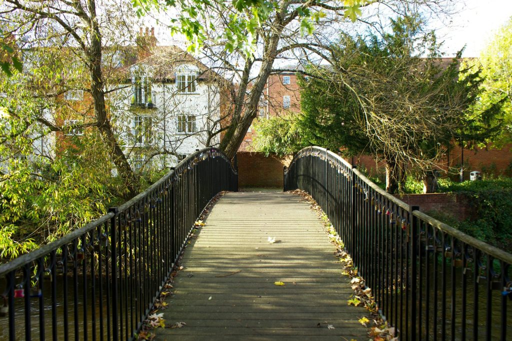 Scenic view of a footbridge in a park in Salisbury, England during autumn.