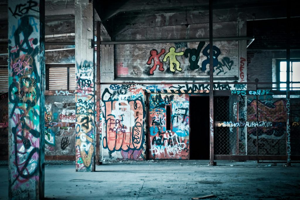 Colorful graffiti art on the walls of an abandoned building, showcasing urban street art culture.