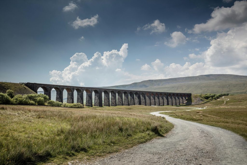 Explore the iconic Ribblehead Viaduct set against the stunning Yorkshire countryside.