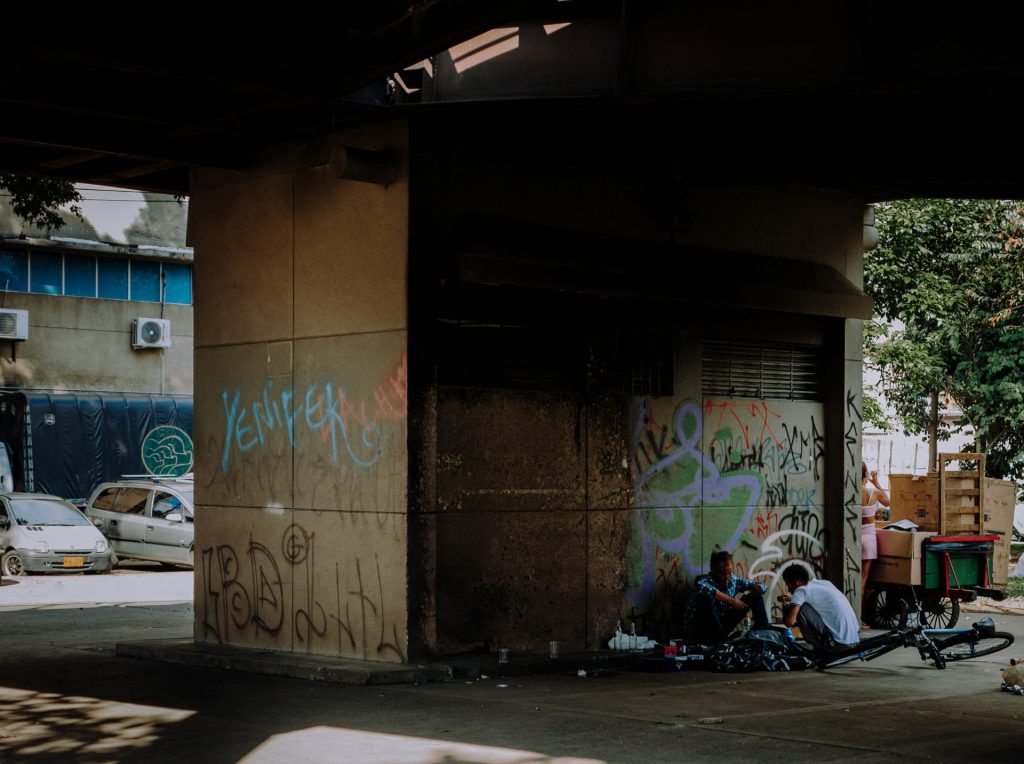 a group of people sitting on the side of a building